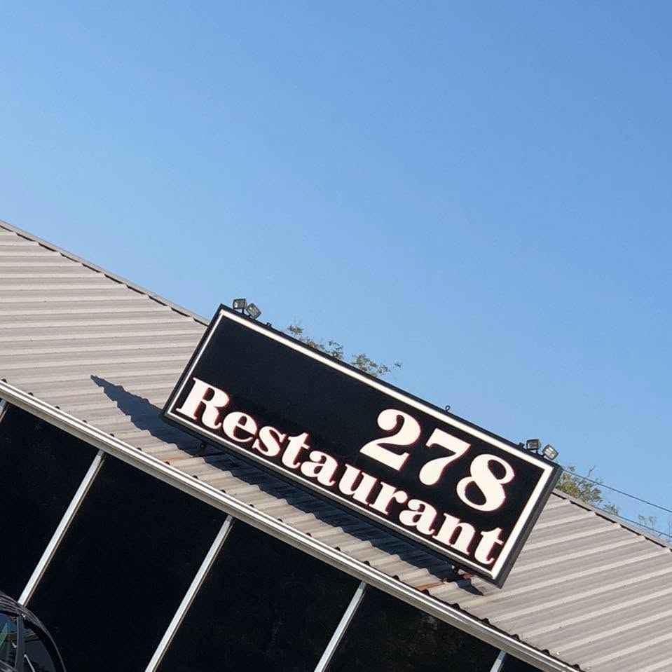 The 278 Restaurant sign on the roof, against a blue Alabama sky